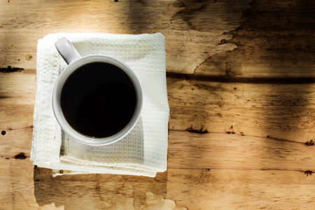 instant coffee in white cup against wood backgroundの写真素材