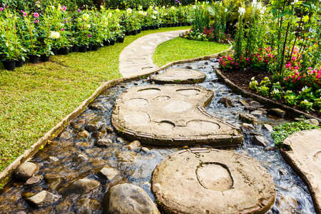 Landscape garden design. The path in the garden with pond in asian style