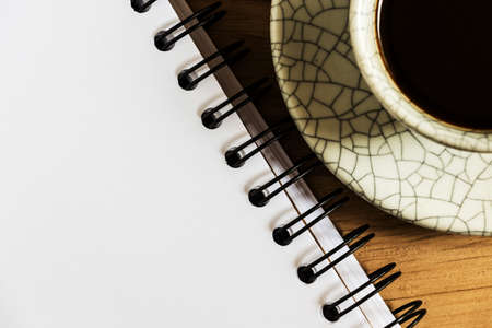 Sketchbook and instant coffeeagainst wood backgroundの写真素材
