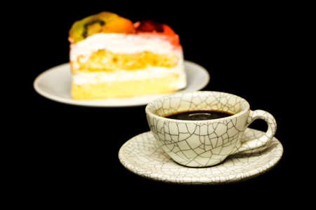 cup of coffee and fruit cake on black backgroundの写真素材