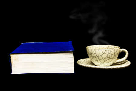 cup of coffee and  book isolated on black background.の写真素材