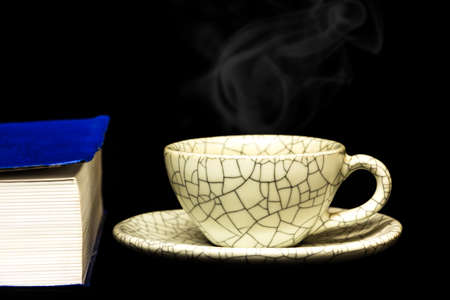 cup of coffee and  book isolated on black background.の写真素材