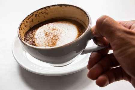 Businessman holding cappuccino cup of coffee.の写真素材