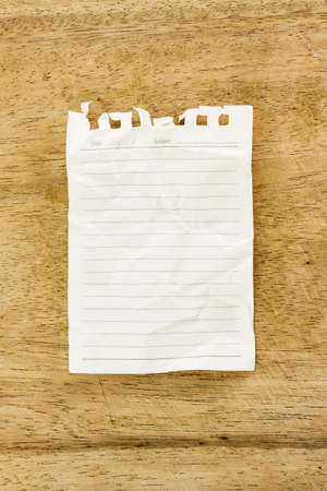 Blank notepad on wooden deskの写真素材