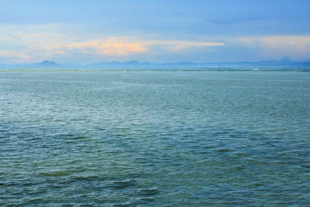 Sky with clouds reflected in water surface at evening sceneの写真素材