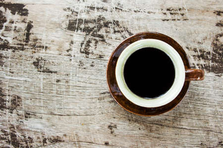 Top view of coffee cup on wood table.の写真素材