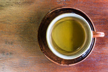Top view of coffee cup on wood table.の写真素材
