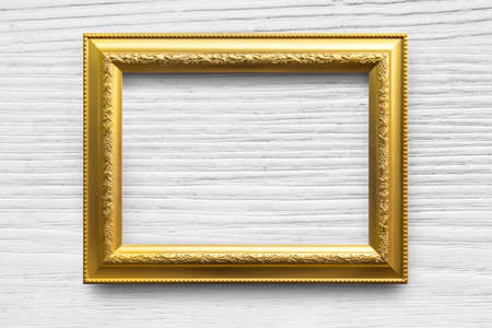 Antique golden frame on white wood background.の写真素材