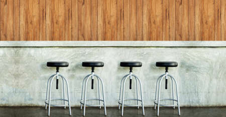 Row chair in concrete room against wooden wall with empty space.の写真素材