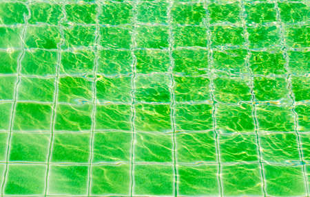 Green tile floor texture background in swimming poolの写真素材