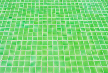 Green tile floor texture background in swimming poolの写真素材