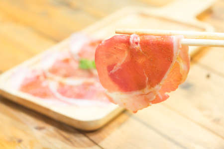 Sliced meat and chopsticks prepare for grill or shabu-shabu.の写真素材