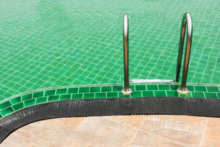 Close up Green Swimming pool with stairの写真素材