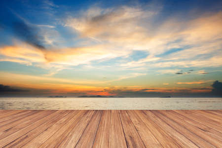 Perspective of wood terrace against beautiful seascape at sunset with free copy space use for background or backdrop.の写真素材