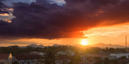 Beautiful sunset over a dark cityscape. Twilight time with dark clouds
