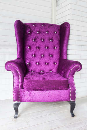 Close up purple chair in white room