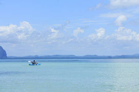 Young man kayaking in the sea.の写真素材