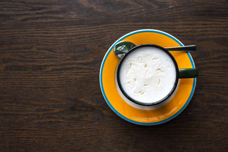 Top view of coffee cup on table.