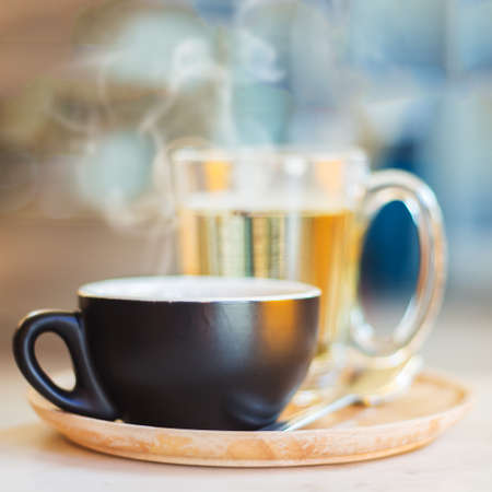 Close up coffee cup with steam on table in cafe. Selective focus.の写真素材