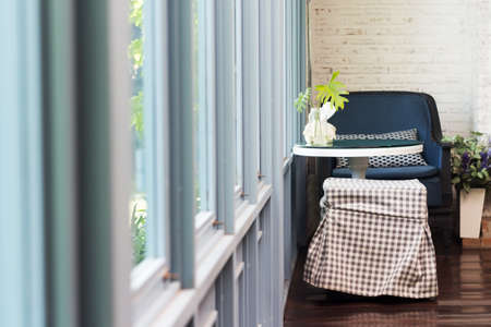 Living room corner with chair and windows and hardwood floor.;の写真素材