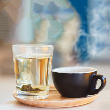 Close up coffee cup with steam on table in cafe. Selective focus.の写真素材