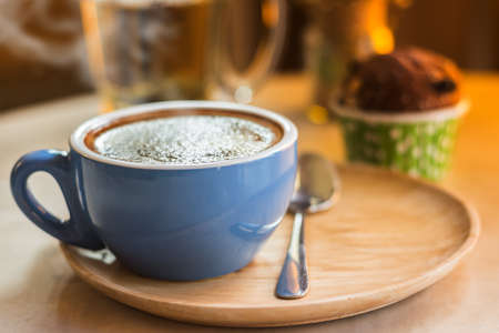 Close up coffee cup with steam on table in cafe. Selective focus.の写真素材