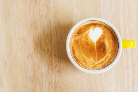 Coffee cup on wood table. Top view.