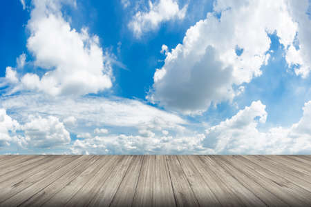 Wood floor against cloudscape with free copy space use for background or backdrop.