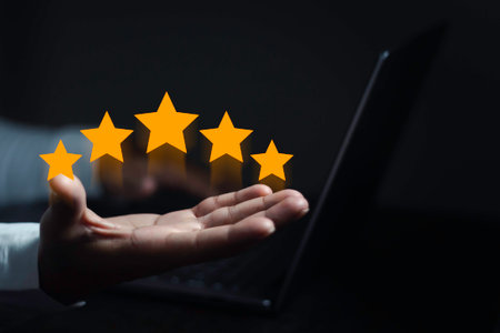 hand of customer or client holding the stars to complete five stars. with copy space. giving a five...