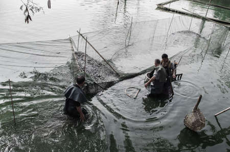 fisherman fishing at pondのeditorial素材