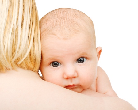 baby on shoulder of her mother on whiteの写真素材