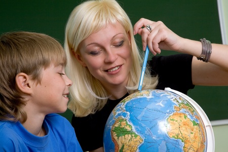 teacher, schoolboy with globeの写真素材