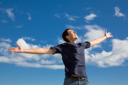 happy man on blue sky backgroundの写真素材