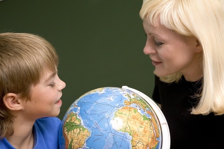 teacher, schoolboy with globeの写真素材