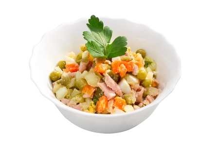 Russian traditional salad olivier. Salad with vegetable and ham in bowl, isolatedの写真素材