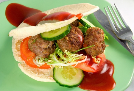 burger with beef patty, cucumber, tomatoの写真素材