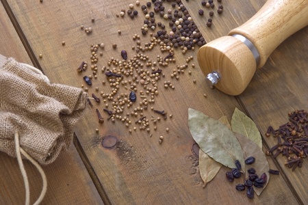 Spice and pepper mill on the wooden tableの写真素材