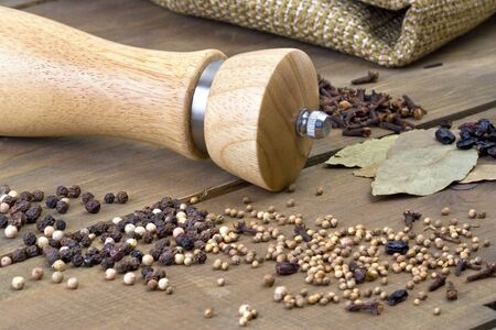 Spice and pepper mill on the wooden tableの写真素材