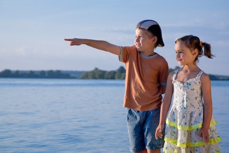 children on beach, boy shows his hand awayの写真素材