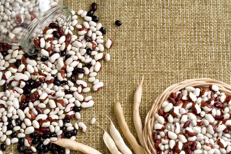 Beans spilled from a jar, beans in a basket, these beansの写真素材