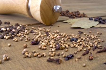 Spice and pepper mill on the wooden tableの写真素材