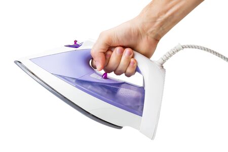 hand with an electric iron, isolatedの写真素材