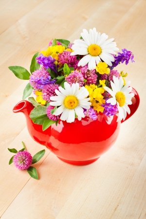 red teapot with bouquet of healing herbs and flowers, herbal medicineの写真素材