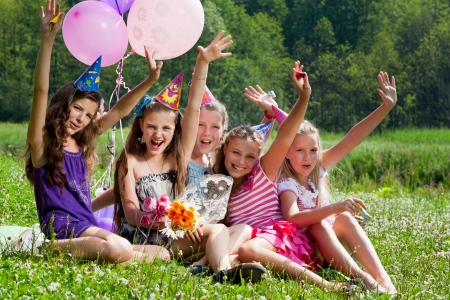 beautiful girls celebrate birthday in summer park outdoorsの写真素材