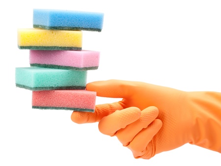 hand in protective glove with dish washing sponge on whiteの写真素材