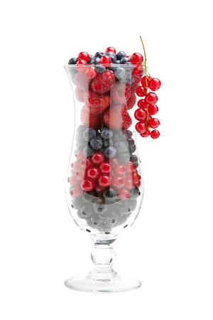 Sweet fresh berries  raspberries, strawberries, blueberries, red currants  in cocktail glass, isolatedの写真素材