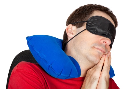 man with travel Neck Pillow and Sleeping mask sleep in a armchairの写真素材