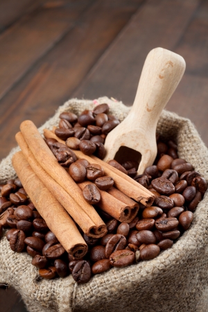 sack with coffee beans and cinnamon, wooden scoopの写真素材
