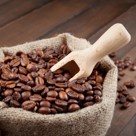 sack with coffee beans and wooden scoopの写真素材