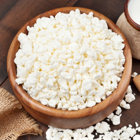 cottage cheese in rustic wooden bowlの写真素材